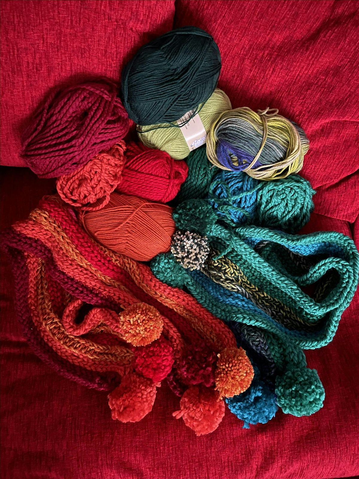 Finger Knit a scarf with Pom Poms. No skill or experience required!